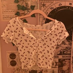 white hollister button up baby tee with brown flowers